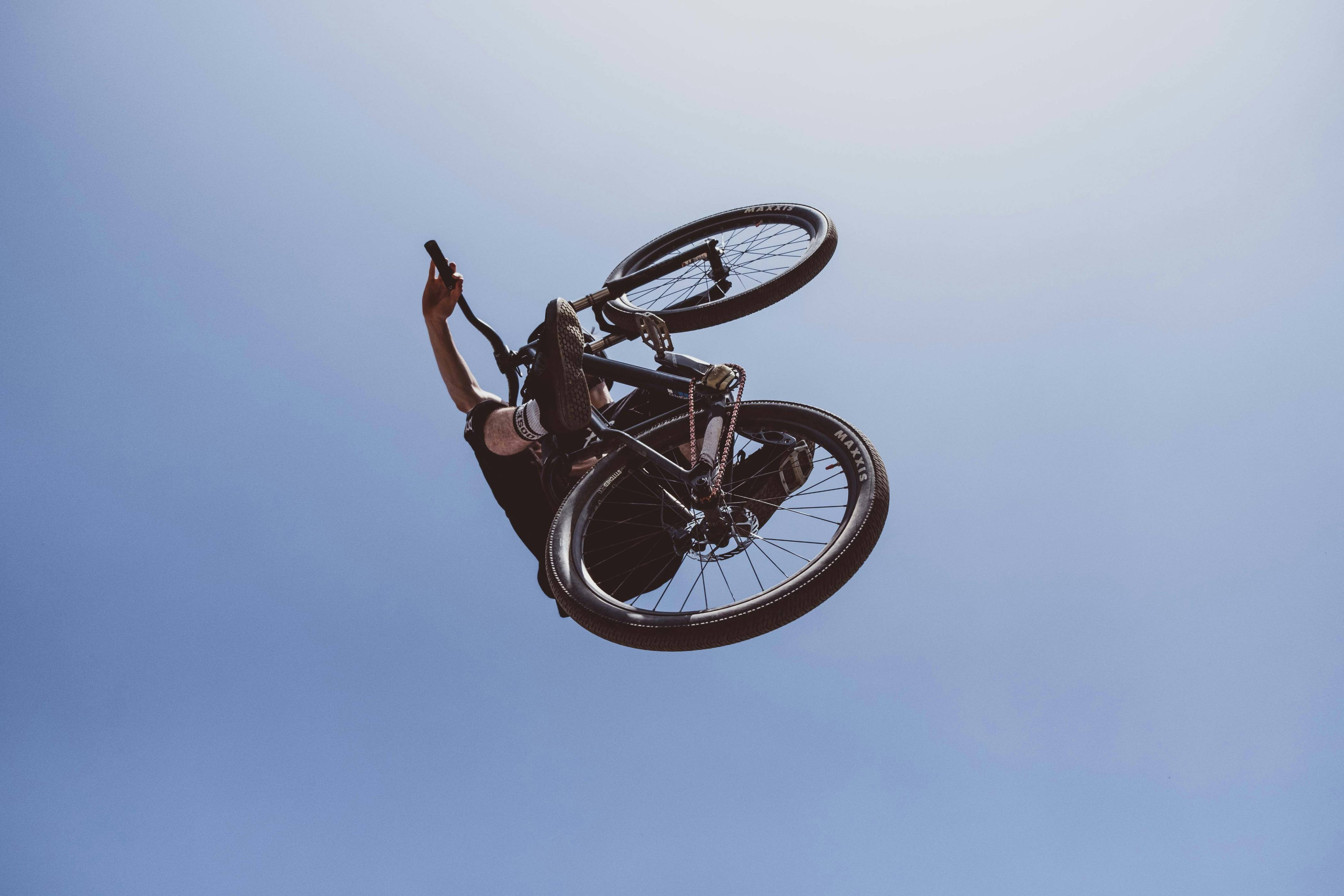 man riding black BMX bike
