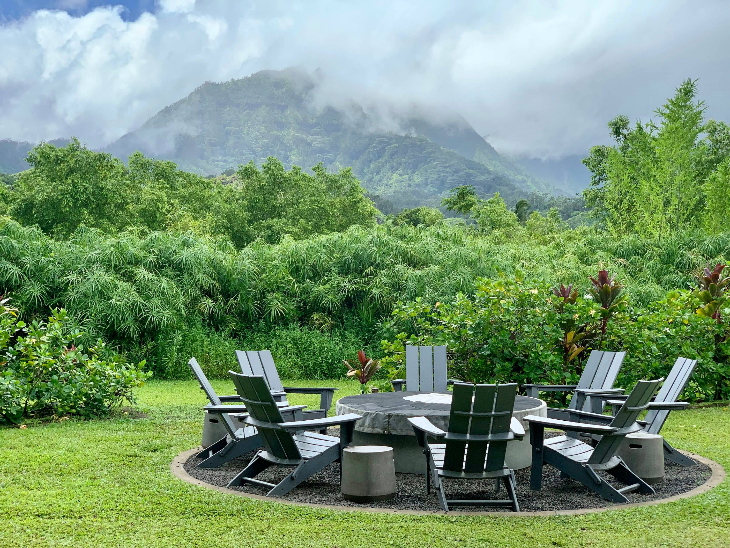 a table and chairs sitting on top of a lush green field