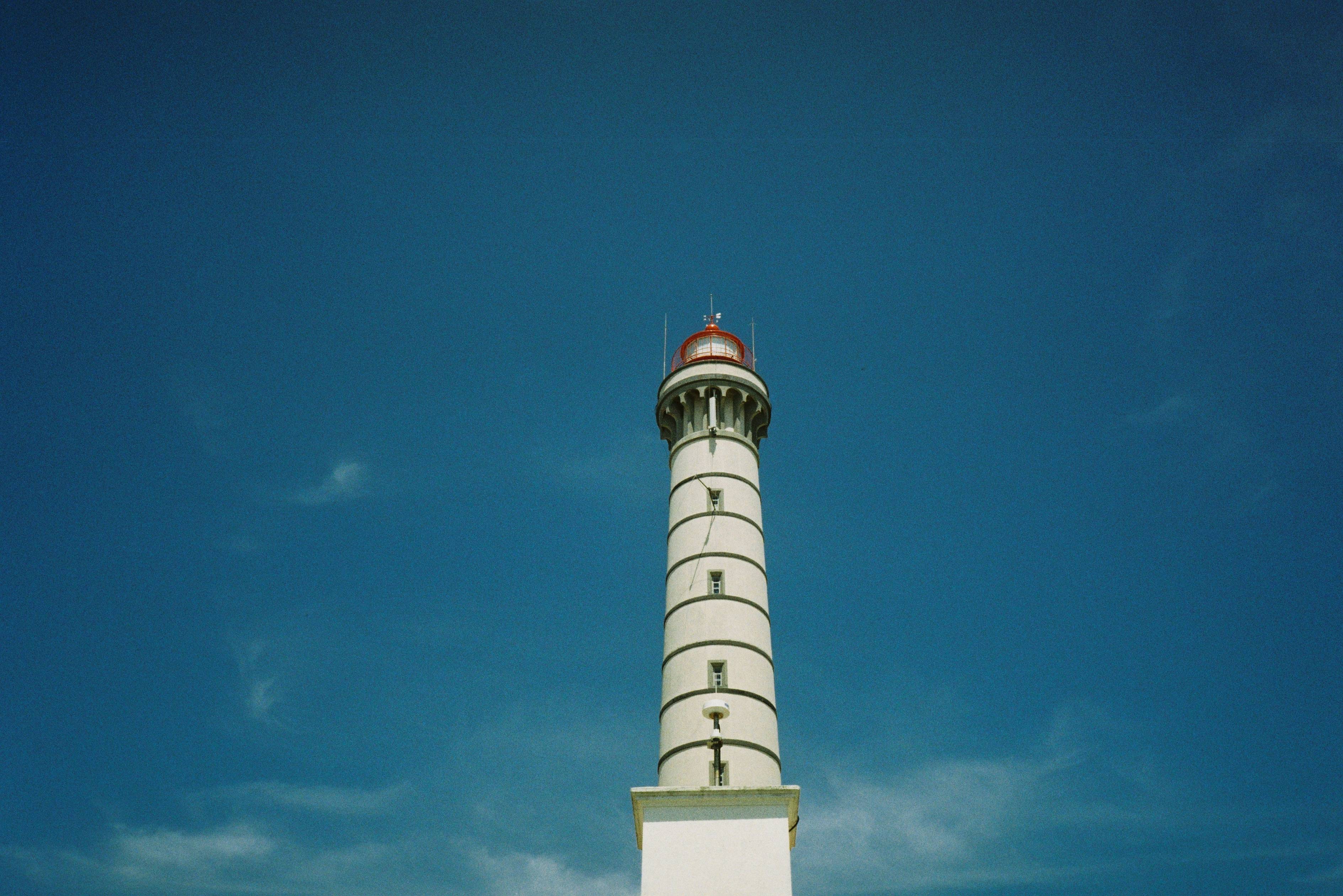 white and brown concrete tower under blue sky during daytime