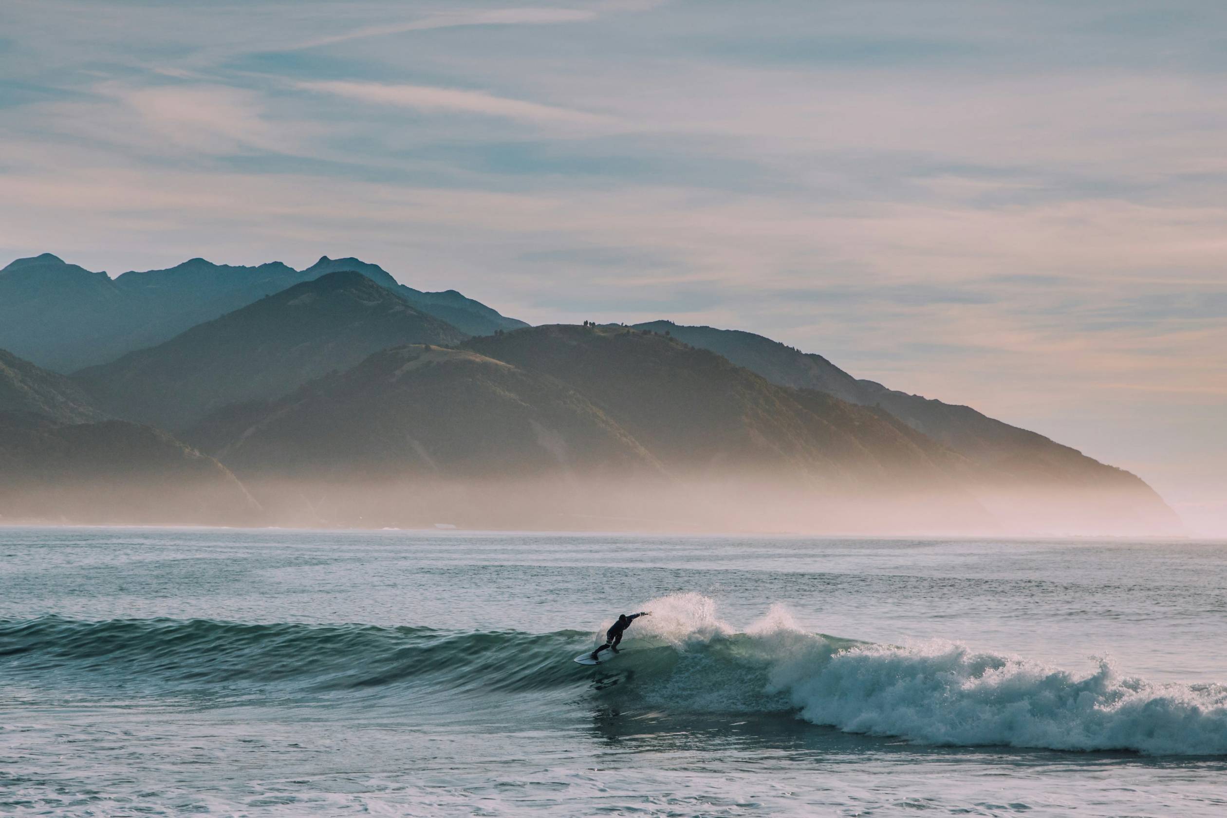person surfing on body of water